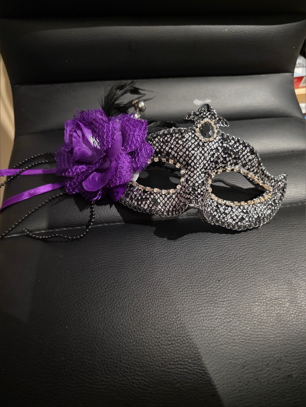 Elegant Black Masquerade Mask with Purple Flower Accent